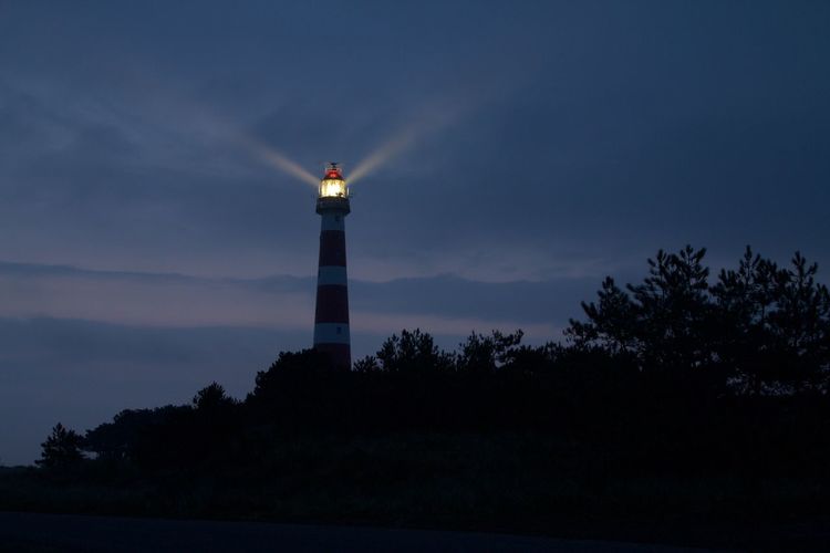 Lighthouse against sky at dusk