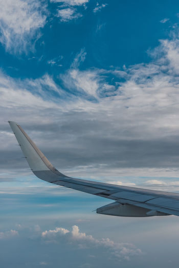 Airplane flying over clouds in sky