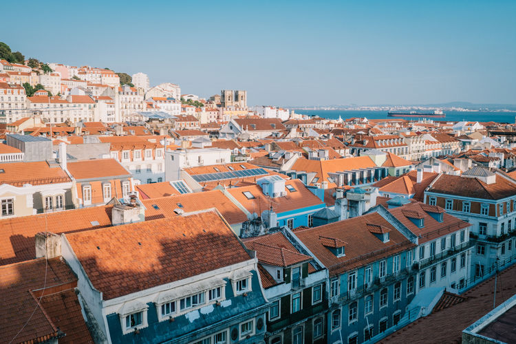 High angle view of houses in town against clear sky