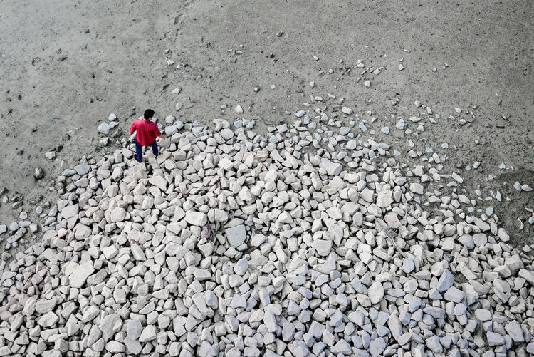 High angle view of man walking on rocks