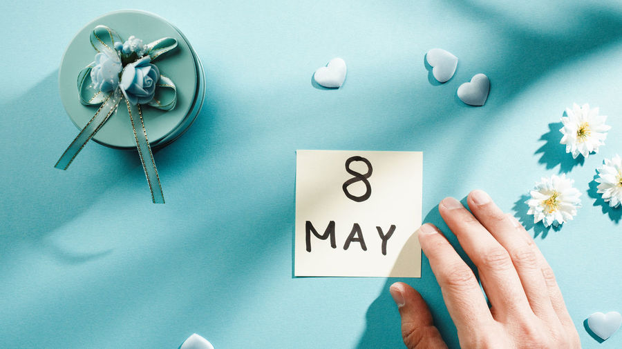 May 8 date for mother's day on a light blue background