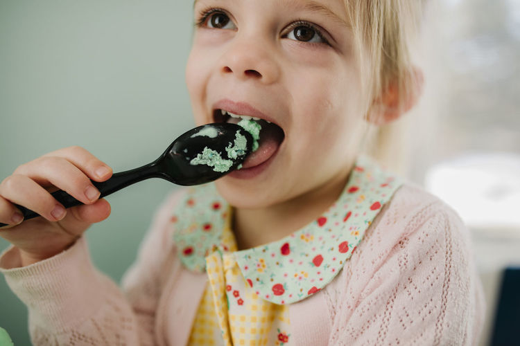 Girl happily eating ice cream