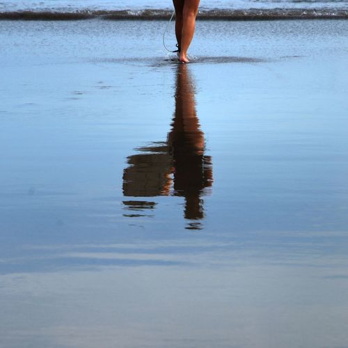 Low section of woman standing in water