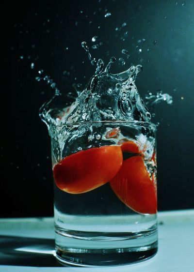 Red tomato drop to water