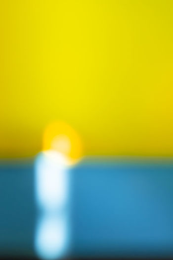 Defocused image of yellow against sky during sunset