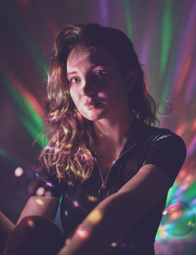 Portrait of woman in illuminated nightclub