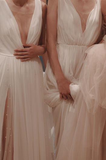 Details of wedding dresses. cropped models. white long dress, fashion vertical shot