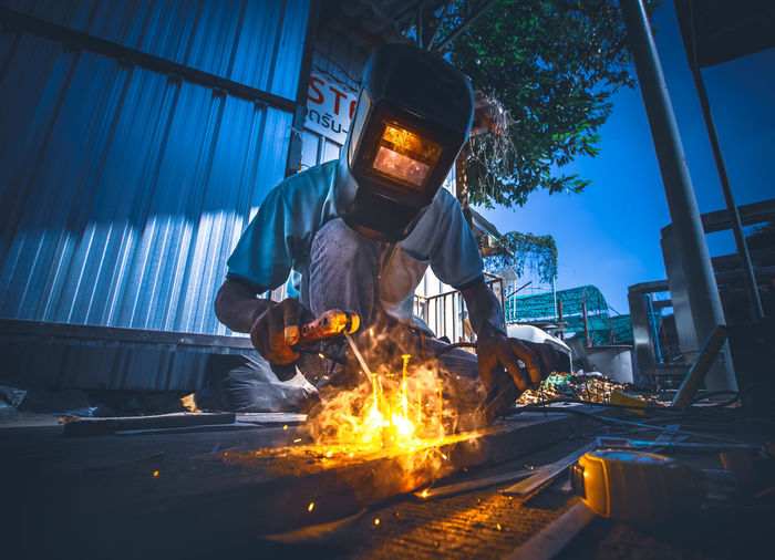 Welder at work in factory