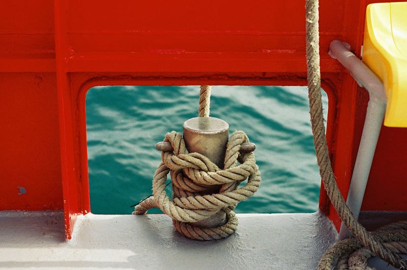 High angle view of rope tied up to cleat on boat 