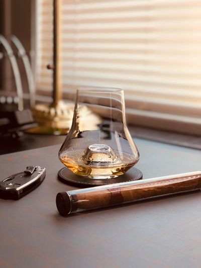 Close-up of whisky glass on table