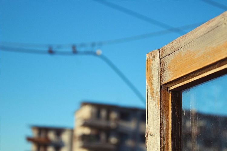 Low angle view of cables against clear blue sky