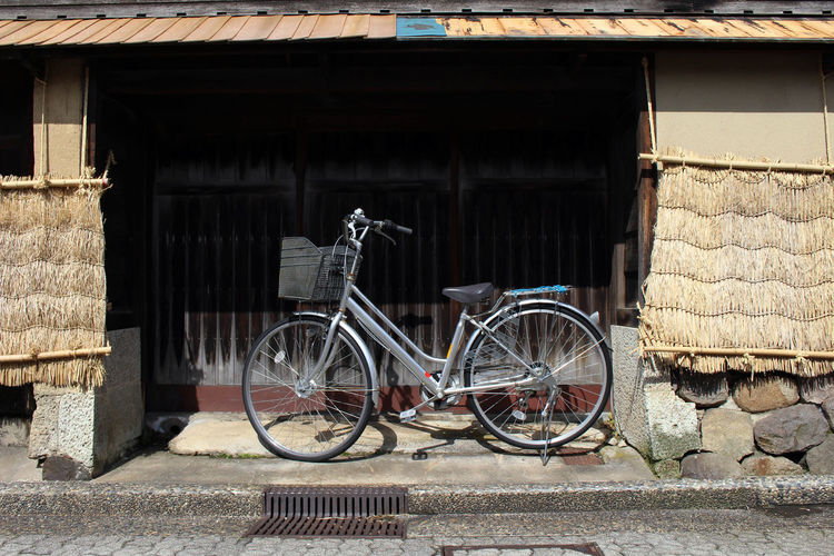 Bicycle parked against wall of old building