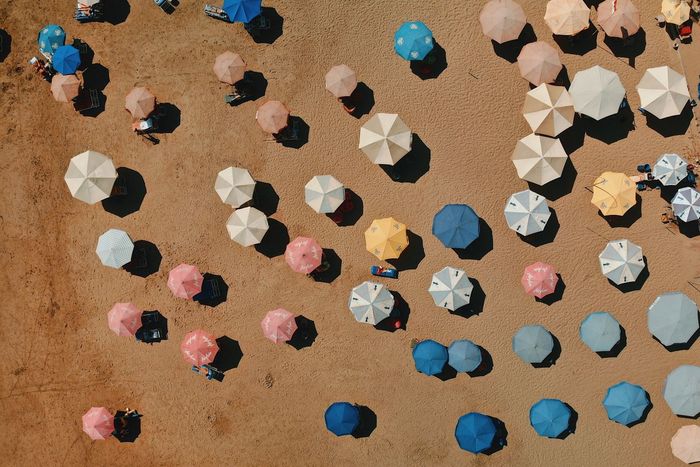 High angle view of multi colored beach umbrellas on sand