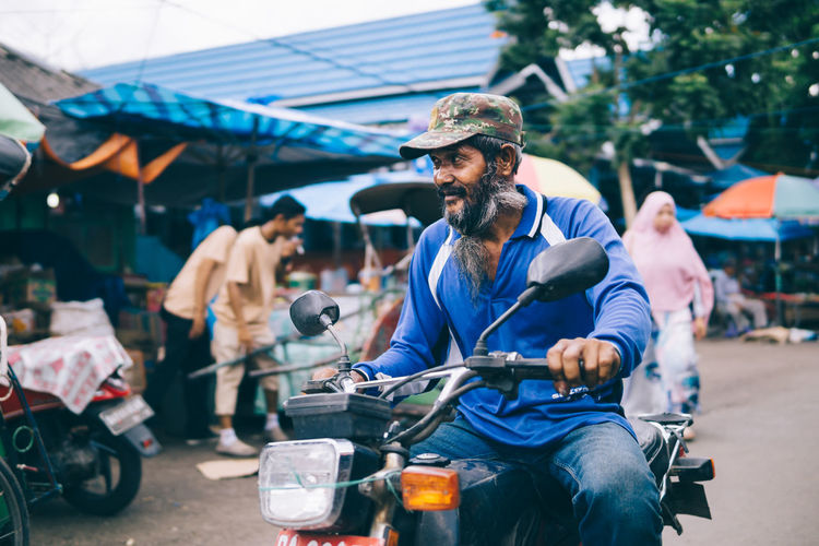 View of man on motorcycle at street market