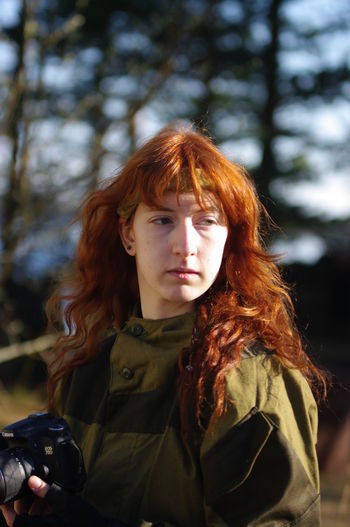 A red-haired girl looking away