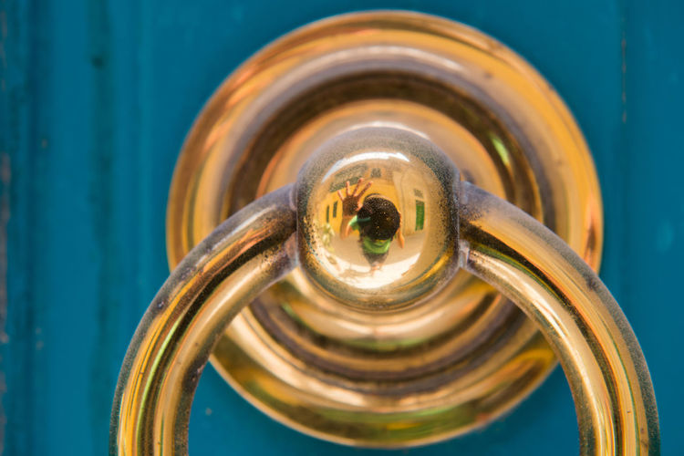 Golden door knocker on a blue wooden door. mdina, malta