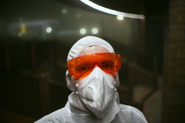 Portrait of man wearing protective goggles in laboratory