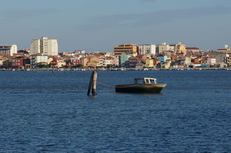 View of sea and buildings against sky