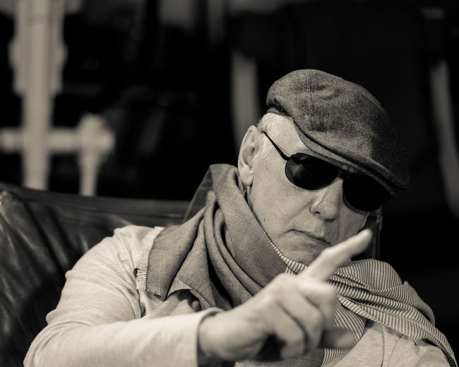 Man wearing sunglasses while sitting on chair