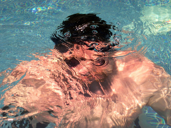 Close-up of young man in swimming pool