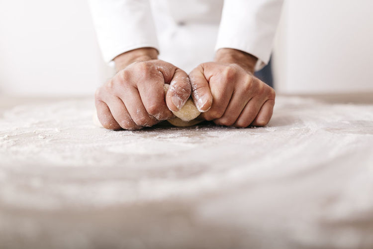 Close-up of man preparing food on table