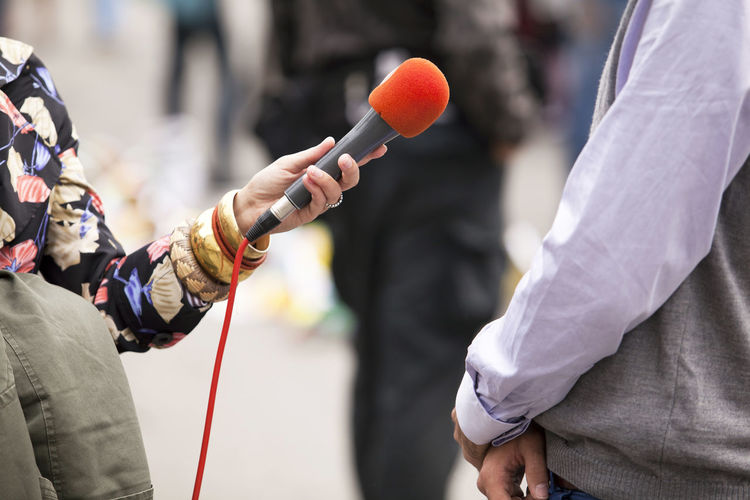 Cropped image of journalist interviewing businessman