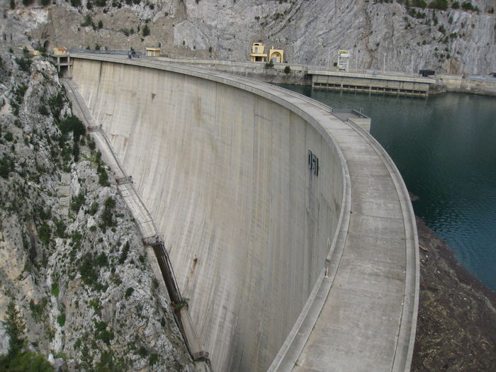 Dam and reservoir against rocky mountain