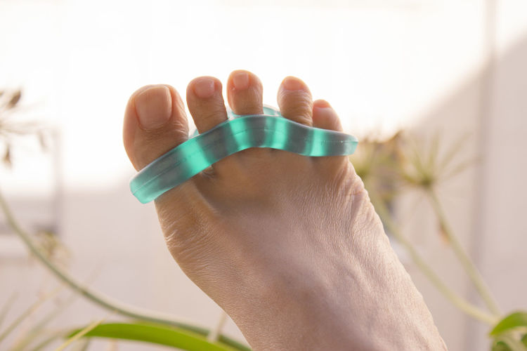 Low section of woman wearing toe divider