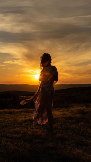 Silhouette of a woman at sunset