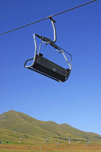 Low angle view of ski lift against clear sky