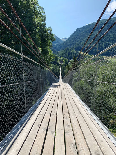 View of footbridge amidst trees