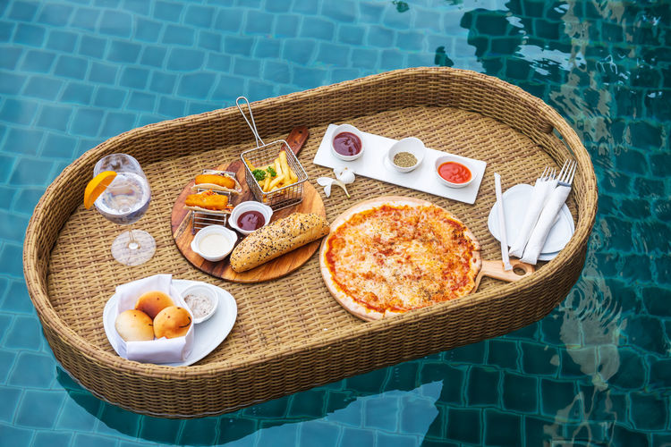 High angle view of breakfast on table by swimming pool