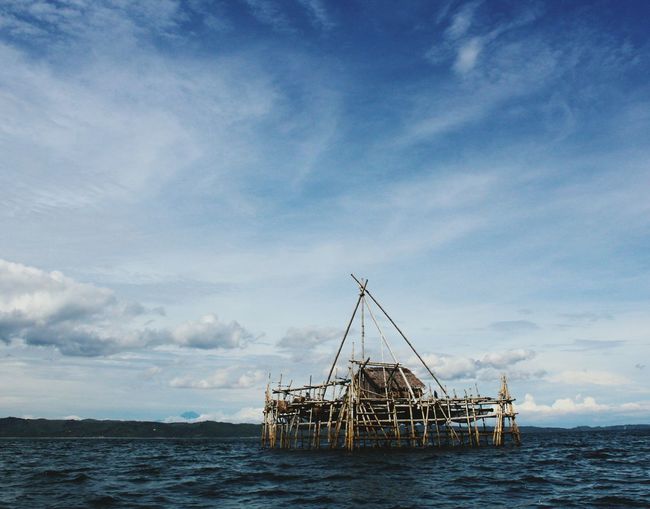 Built structure in sea against sky