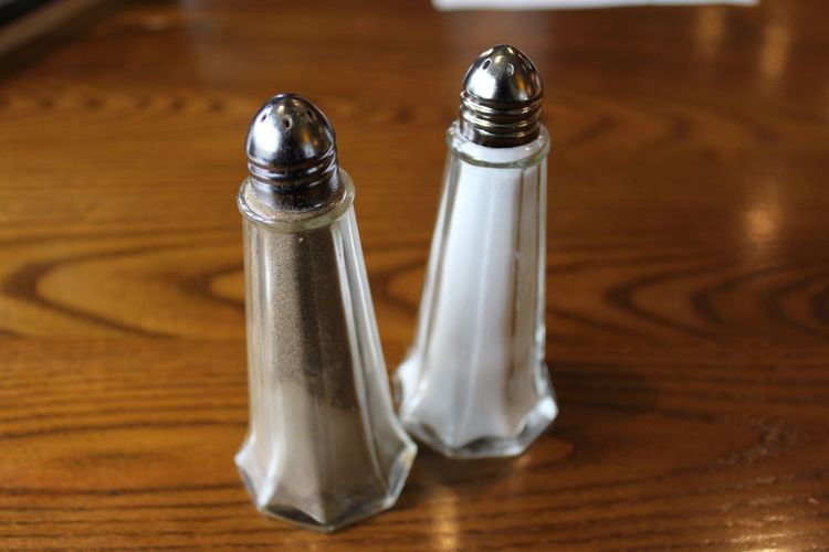Close-up of salt and pepper shakers on table