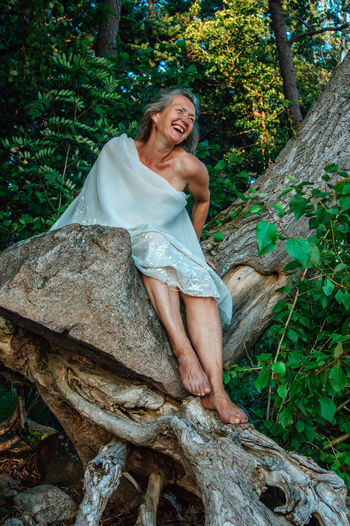Portrait of smiling mature woman in the forest