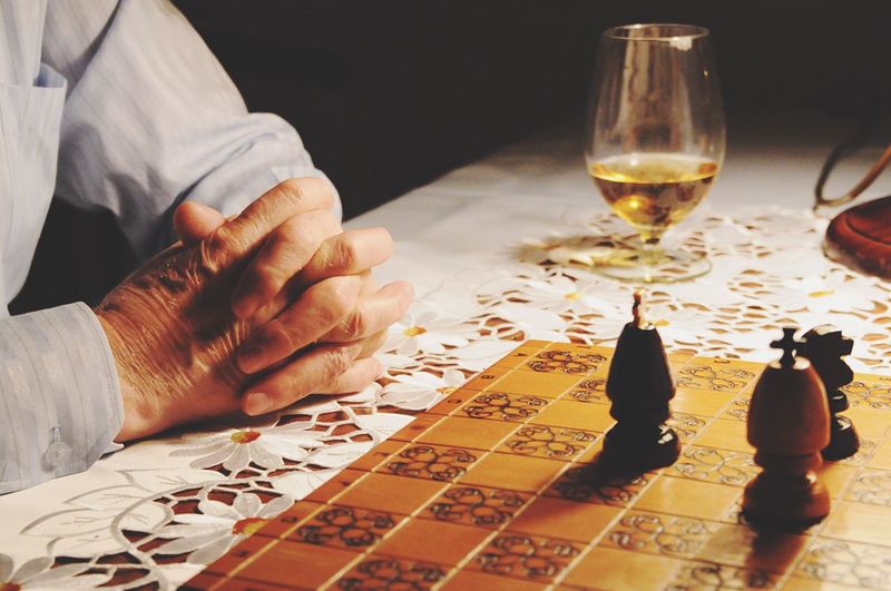 Close-up of man playing chess