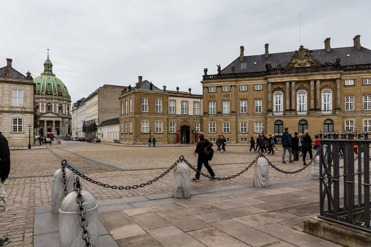  group of people in front of the palaces of amalienborg