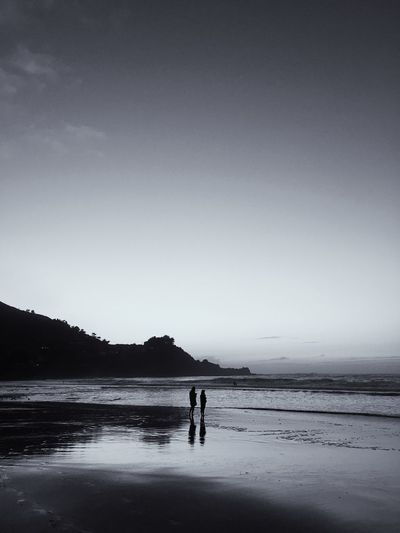 People standing on shore at beach