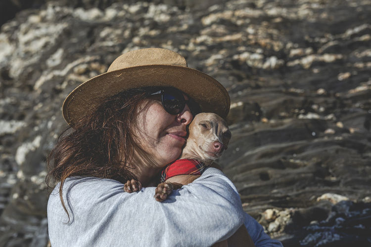 Mature woman with dog at beach