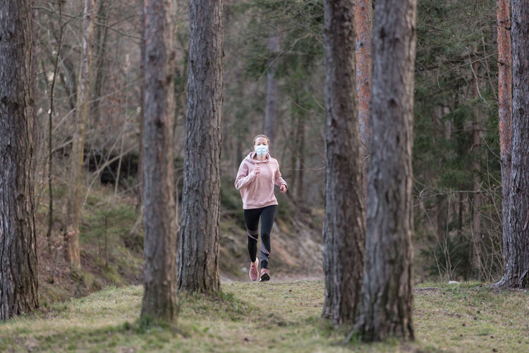 Full length of woman running in forest
