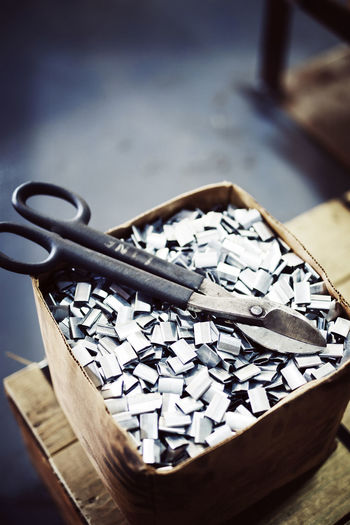 High angle view of equipment on steel chips in box
