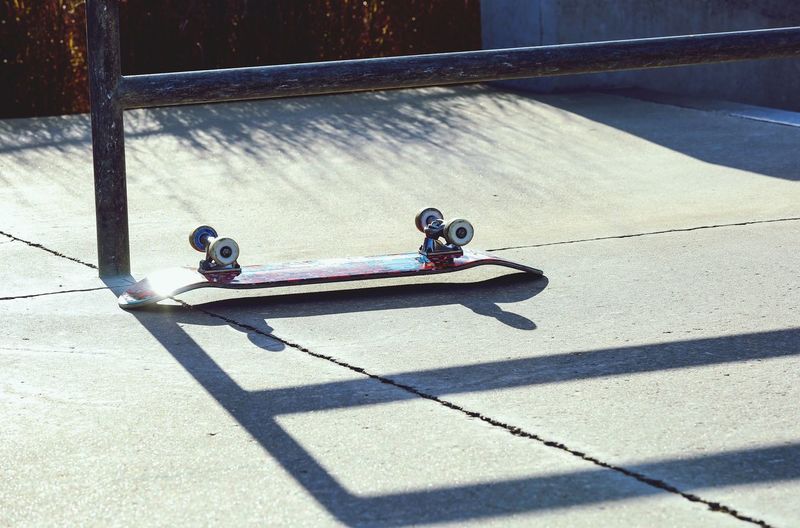 High angle view of skateboard on footpath