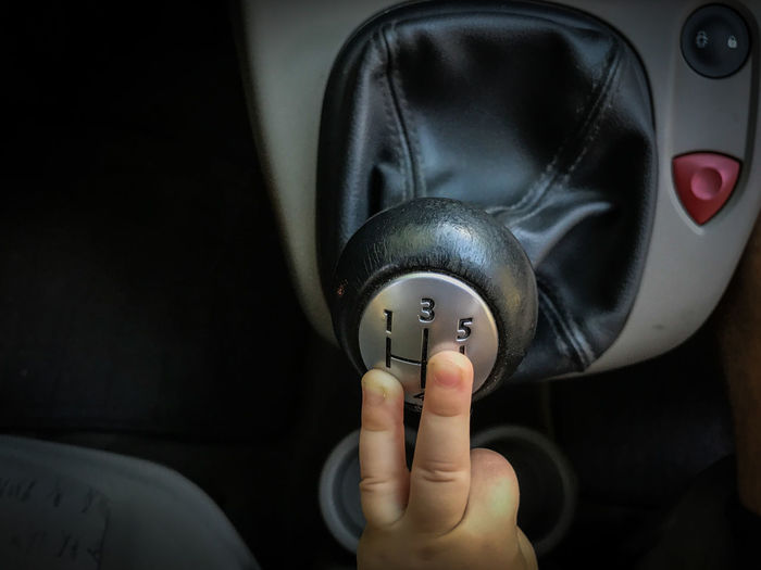Cropped hand of child playing with gearshift