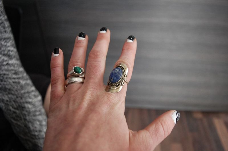 Close-up of woman hand showing rings and nail polish