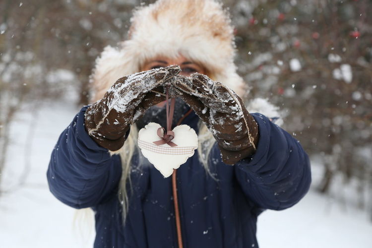 Close-up portrait of human hand on snow