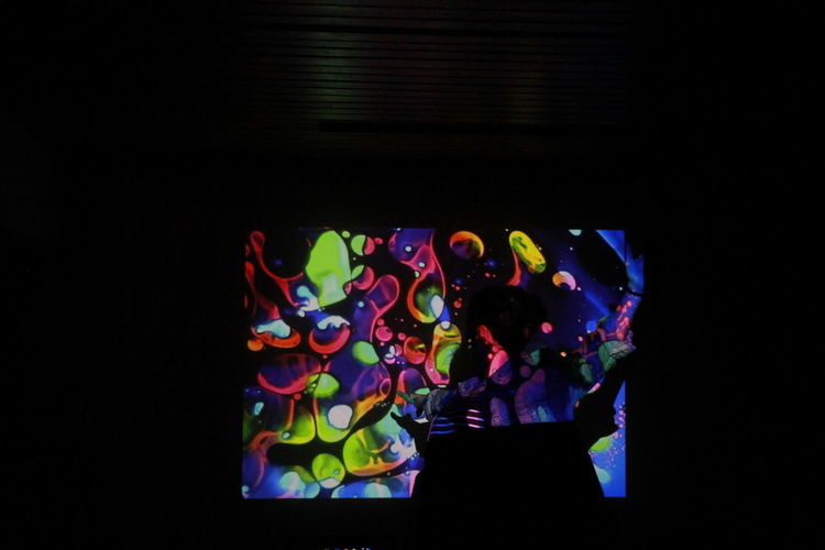 Close-up of illuminated lighting equipment against black background