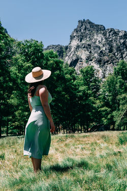 Rear view of woman wearing hat against trees