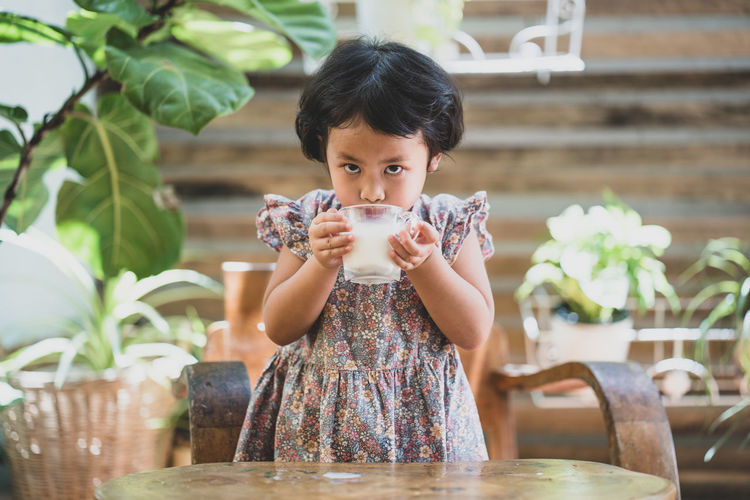 Portrait of girl drinking milk