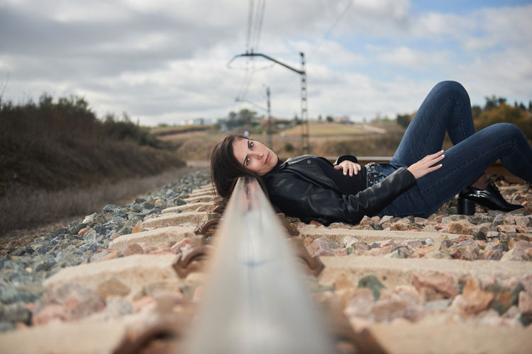 An attractive girl lying quietly on the rails of the train.