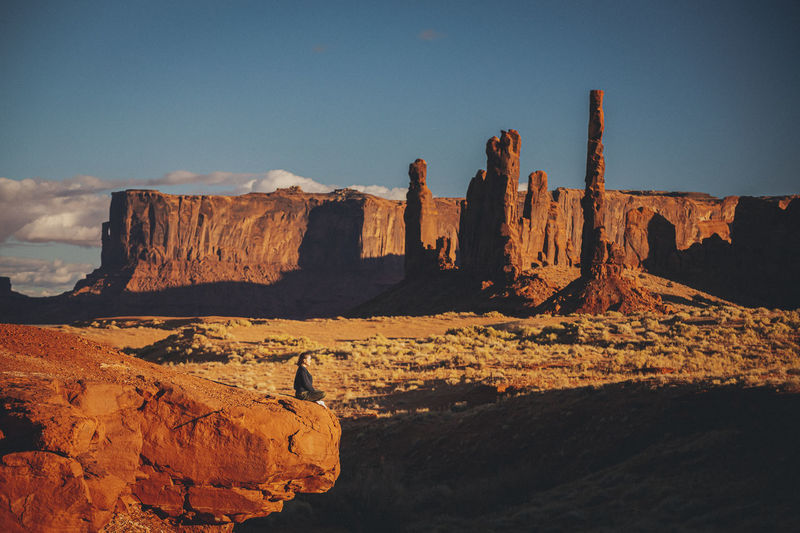 A woman is meditating in monument valley, arizona